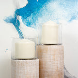 Pairing a few candleholders with different sizes for a warm and modern interior